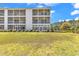 The back of the condo reveals expansive screened porches overlooking lush grassy common area surrounded by tall mature trees at 1505 Lanterns Rest Rd. # 101, Myrtle Beach, SC 29579