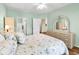 Comfortable bedroom shows ample lighting, hard wood floors, and ensuite bath at 1505 Lanterns Rest Rd. # 101, Myrtle Beach, SC 29579