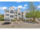 Attractive three-story condo building with white siding and well-maintained landscaping and ample parking space at 1505 Lanterns Rest Rd. # 101, Myrtle Beach, SC 29579