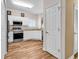 Clean kitchen with white cabinets, stainless steel appliances, wood floors, and natural light at 1505 Lanterns Rest Rd. # 101, Myrtle Beach, SC 29579