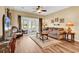 Comfortable living room featuring cozy seating, wood floors, and views of the screened in back porch at 1505 Lanterns Rest Rd. # 101, Myrtle Beach, SC 29579
