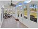 Bright sunroom with tile flooring, ceiling fan, and expansive views of the landscaped yard at 1505 Lanterns Rest Rd. # 101, Myrtle Beach, SC 29579