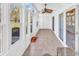 Inviting sunroom features tile flooring, ceiling fan, and multiple windows with outdoor views at 1505 Lanterns Rest Rd. # 101, Myrtle Beach, SC 29579
