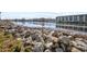 Scenic waterfront view with rocky shoreline and calm water leading to residential buildings at 1505 Lanterns Rest Rd. # 101, Myrtle Beach, SC 29579