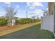 A grassy backyard with privacy fence, bushes and welcome sign at 154 Sea Shell Dr. # 16, Murrells Inlet, SC 29576