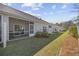 A grassy backyard with a row of townhouses featuring screened in porches and air conditioning units at 154 Sea Shell Dr. # 16, Murrells Inlet, SC 29576