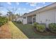 A grassy backyard and townhouses featuring screened in porches and air conditioning units at 154 Sea Shell Dr. # 16, Murrells Inlet, SC 29576