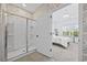 Bathroom with glass shower door leads to a bedroom with coastal style decor and light at 154 Sea Shell Dr. # 16, Murrells Inlet, SC 29576