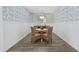 Charming dining area with glass table, stylish wallpaper, and wainscoting at 154 Sea Shell Dr. # 16, Murrells Inlet, SC 29576