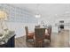 Elegant dining area showcasing chandelier, stylish wallpaper, and adjoining living space at 154 Sea Shell Dr. # 16, Murrells Inlet, SC 29576