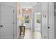 Bright hallway showcasing elegant chandelier, decorative wainscoting, and light hardwood flooring at 154 Sea Shell Dr. # 16, Murrells Inlet, SC 29576