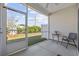 Screened in porch with black patio furniture looking out onto green grass and blue skies at 154 Sea Shell Dr. # 16, Murrells Inlet, SC 29576
