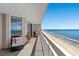 Balcony overlooking the beach and ocean, furnished with chairs and a small table at 1625 S Ocean Blvd. # 1510, North Myrtle Beach, SC 29582