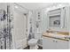 Bathroom featuring a shower-tub combo, white fixtures, granite countertop, and decorative artwork at 1625 S Ocean Blvd. # 1510, North Myrtle Beach, SC 29582