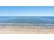 Wide sandy beach with gentle waves meeting the shore on a clear sunny day at 1625 S Ocean Blvd. # 1510, North Myrtle Beach, SC 29582