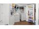 Functional laundry room equipped with a washer, dryer, and ample shelving for storage at 1625 S Ocean Blvd. # 1510, North Myrtle Beach, SC 29582