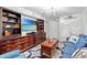 Bright living room featuring a flat-screen TV, custom shelving, and comfortable blue seating at 1625 S Ocean Blvd. # 1510, North Myrtle Beach, SC 29582