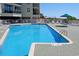 Inviting pool with lounge chairs, tables, and a clear blue sky perfect for outdoor enjoyment at 1625 S Ocean Blvd. # 1510, North Myrtle Beach, SC 29582