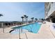 Stunning pool area with palm trees, comfortable lounge chairs, and ocean views for relaxation at 1625 S Ocean Blvd. # 1510, North Myrtle Beach, SC 29582