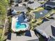 Aerial view showcasing the community pool, pond with fountain, and surrounding homes in a lush, green neighborhood at 173 Knight Circle # 1, Pawleys Island, SC 29585