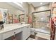 Well-lit bathroom featuring a spacious vanity, framed mirror and a tiled walk-in shower with a glass door at 173 Knight Circle # 1, Pawleys Island, SC 29585