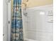 Clean bathroom showcasing a shower and tub combination with white tiled walls and a decorative shower curtain at 173 Knight Circle # 1, Pawleys Island, SC 29585