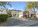 Inviting single-story home with brick and siding, two-car garage, and covered porch, framed by mature trees at 173 Knight Circle # 1, Pawleys Island, SC 29585