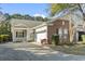Charming single-story home featuring brick and siding exterior, a two-car garage, and a welcoming porch at 173 Knight Circle # 1, Pawleys Island, SC 29585