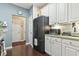 Functional kitchen area with a black refrigerator, ample cabinet space, and hardwood floors at 173 Knight Circle # 1, Pawleys Island, SC 29585