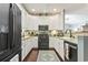 Well-equipped kitchen featuring black appliances, white cabinets, and hardwood flooring at 173 Knight Circle # 1, Pawleys Island, SC 29585