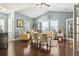 Inviting living room with vaulted ceilings, hardwood floors, and abundant natural light from large windows at 173 Knight Circle # 1, Pawleys Island, SC 29585
