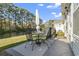 Charming outdoor patio with dining set overlooking water feature and lush landscaping at 173 Knight Circle # 1, Pawleys Island, SC 29585