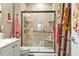 Attractive walk-in shower with a glass door, tiled walls, built-in bench and shower head at 173 Knight Circle # 1, Pawleys Island, SC 29585