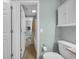 Hallway leading to a bathroom with tile floor, shower with curtain, and cabinets at 178 Salt Marsh Circle # 30D, Pawleys Island, SC 29585