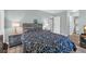 Cozy bedroom featuring a floral-patterned comforter, wood headboard, and access to an ensuite bathroom at 178 Salt Marsh Circle # 30D, Pawleys Island, SC 29585