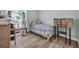 Bright bedroom with hardwood floors, a plaid comforter, and a window view at 178 Salt Marsh Circle # 30D, Pawleys Island, SC 29585