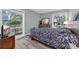 Bright bedroom featuring hardwood floors, a floral comforter, and natural light from the windows at 178 Salt Marsh Circle # 30D, Pawleys Island, SC 29585