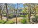 Landscaped condo exterior with trees, shrubs, and a well-maintained lawn at 178 Salt Marsh Circle # 30D, Pawleys Island, SC 29585