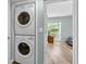Convenient laundry area with stacked washer and dryer, leading into a bright bedroom space at 178 Salt Marsh Circle # 30D, Pawleys Island, SC 29585