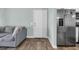 Comfortable living room featuring a large sofa, stainless steel fridge, and convenient access to the outside at 178 Salt Marsh Circle # 30D, Pawleys Island, SC 29585