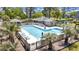Inviting community pool area with lounge chairs, palm trees, and a cabana at 178 Salt Marsh Circle # 30D, Pawleys Island, SC 29585