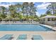 Community pool featuring lounge chairs and a gazebo in a quiet, wooded setting at 178 Salt Marsh Circle # 30D, Pawleys Island, SC 29585