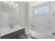 This bathroom has a shower and vanity with grey cabinets at 2191 Gooseberry Way, Longs, SC 29568