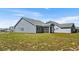 Angle view of the home's rear exterior showing its screened in porch and backyard at 2191 Gooseberry Way, Longs, SC 29568