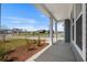 Spacious covered porch with scenic views of the neighborhood at 2191 Gooseberry Way, Longs, SC 29568