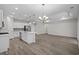 Spacious open kitchen with white cabinets, stainless steel appliances, island, and pendant lighting at 2191 Gooseberry Way, Longs, SC 29568