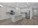 Modern kitchen featuring stainless steel appliances, white cabinetry, and a central island with quartz countertop at 2191 Gooseberry Way, Longs, SC 29568