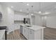 Open concept kitchen with white cabinets, stainless steel appliances, and large center island at 2191 Gooseberry Way, Longs, SC 29568