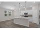 Bright kitchen with island, stainless appliances, mosaic backsplash, and an adjacent dining area at 2191 Gooseberry Way, Longs, SC 29568