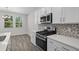 Contemporary kitchen featuring stainless steel appliances and white cabinets at 2191 Gooseberry Way, Longs, SC 29568